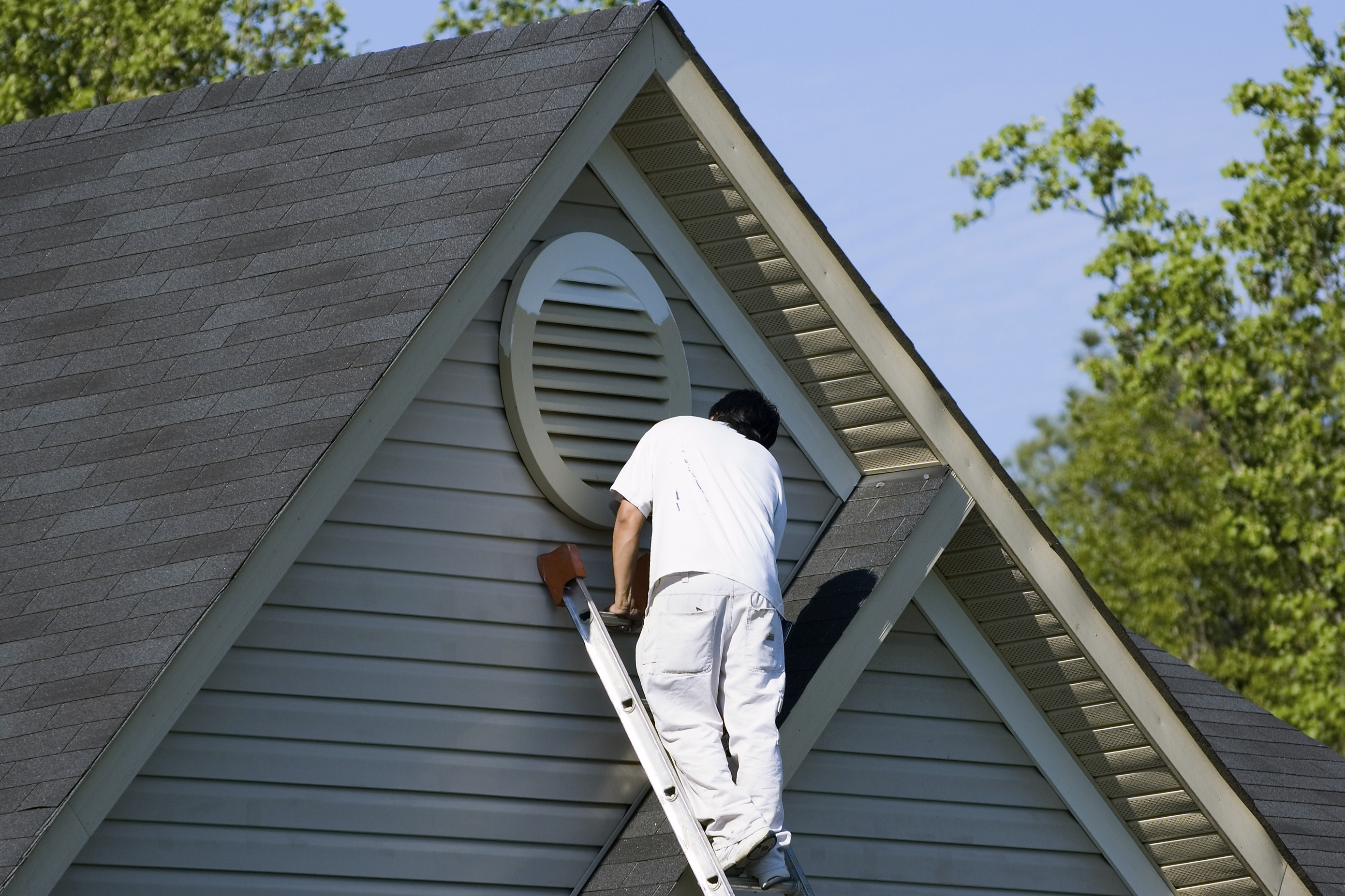 man painting homes exterior in Hanover, PA